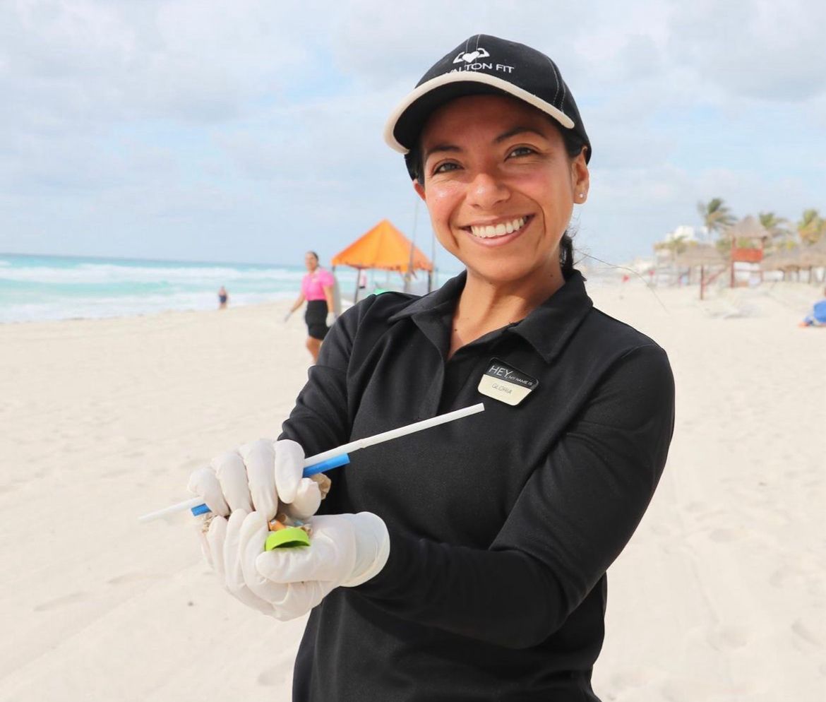 a woman holding a golf ball on a beach