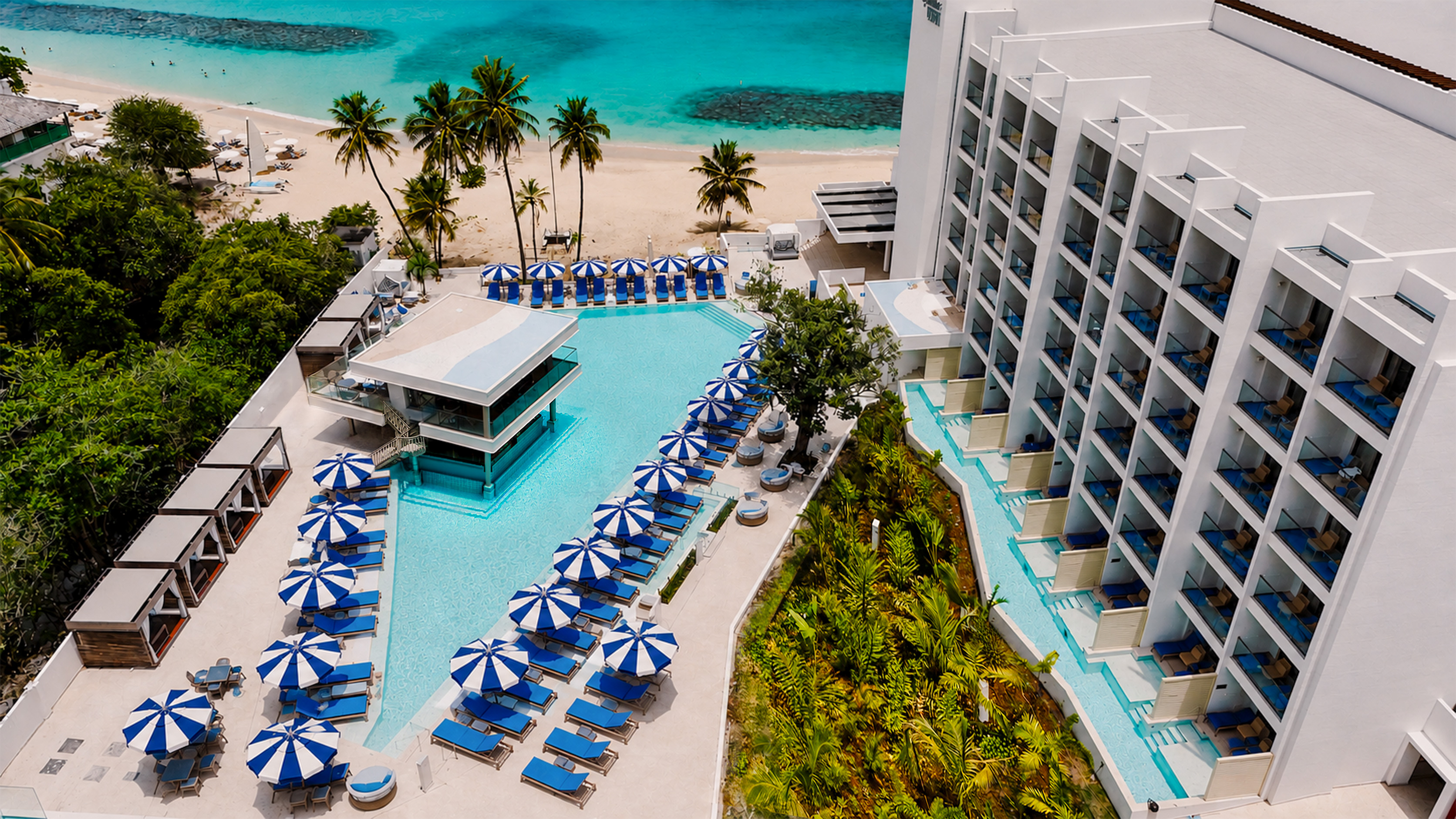 a swimming pool with umbrellas and chairs on a beach