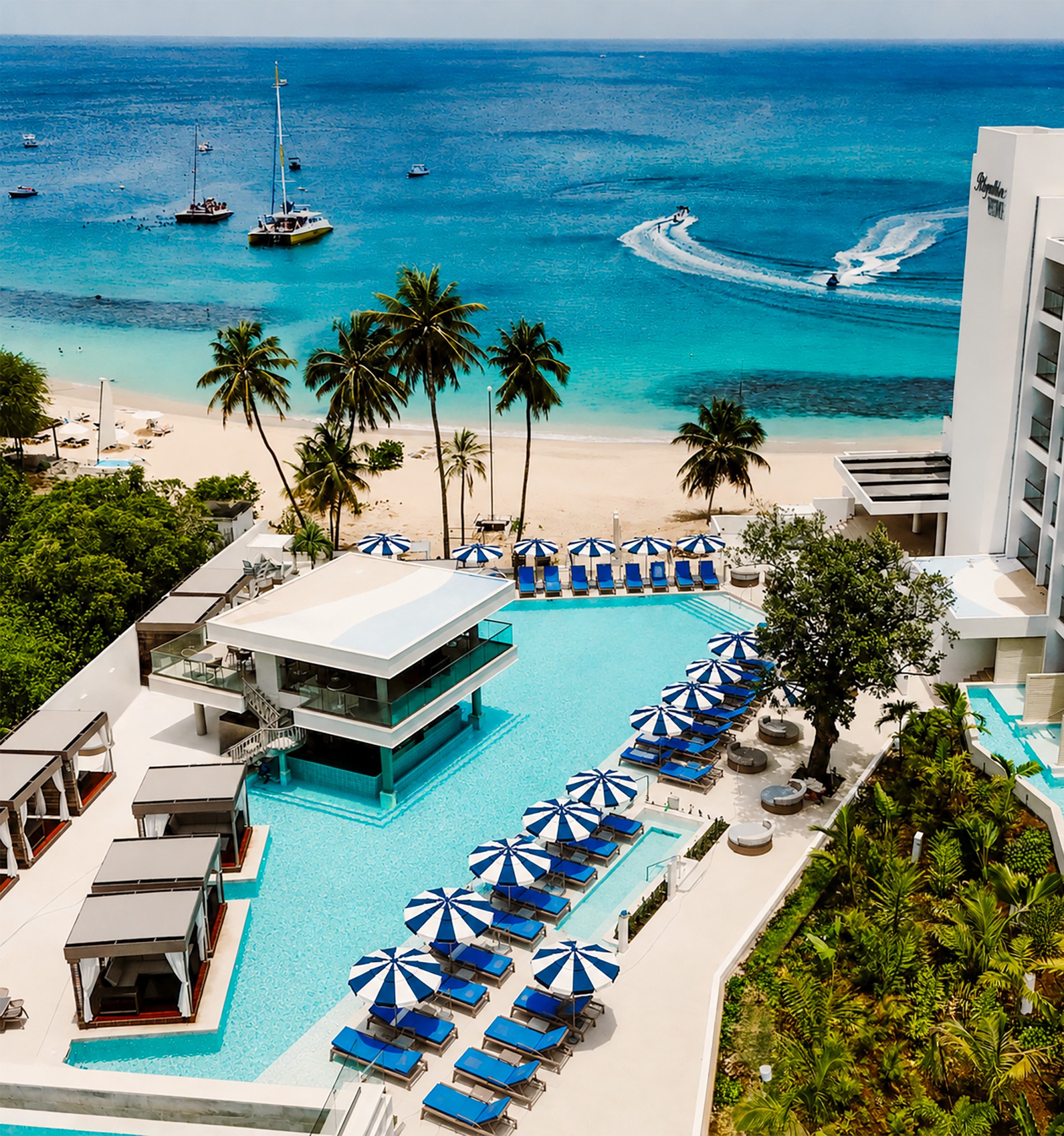 a swimming pool with umbrellas and chairs on a beach