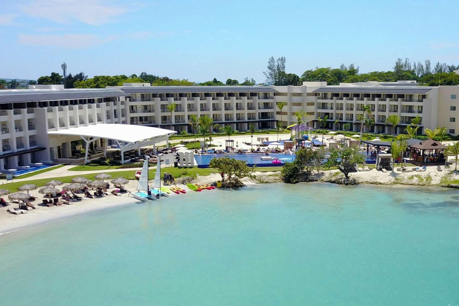 a hotel with a pool and a beach