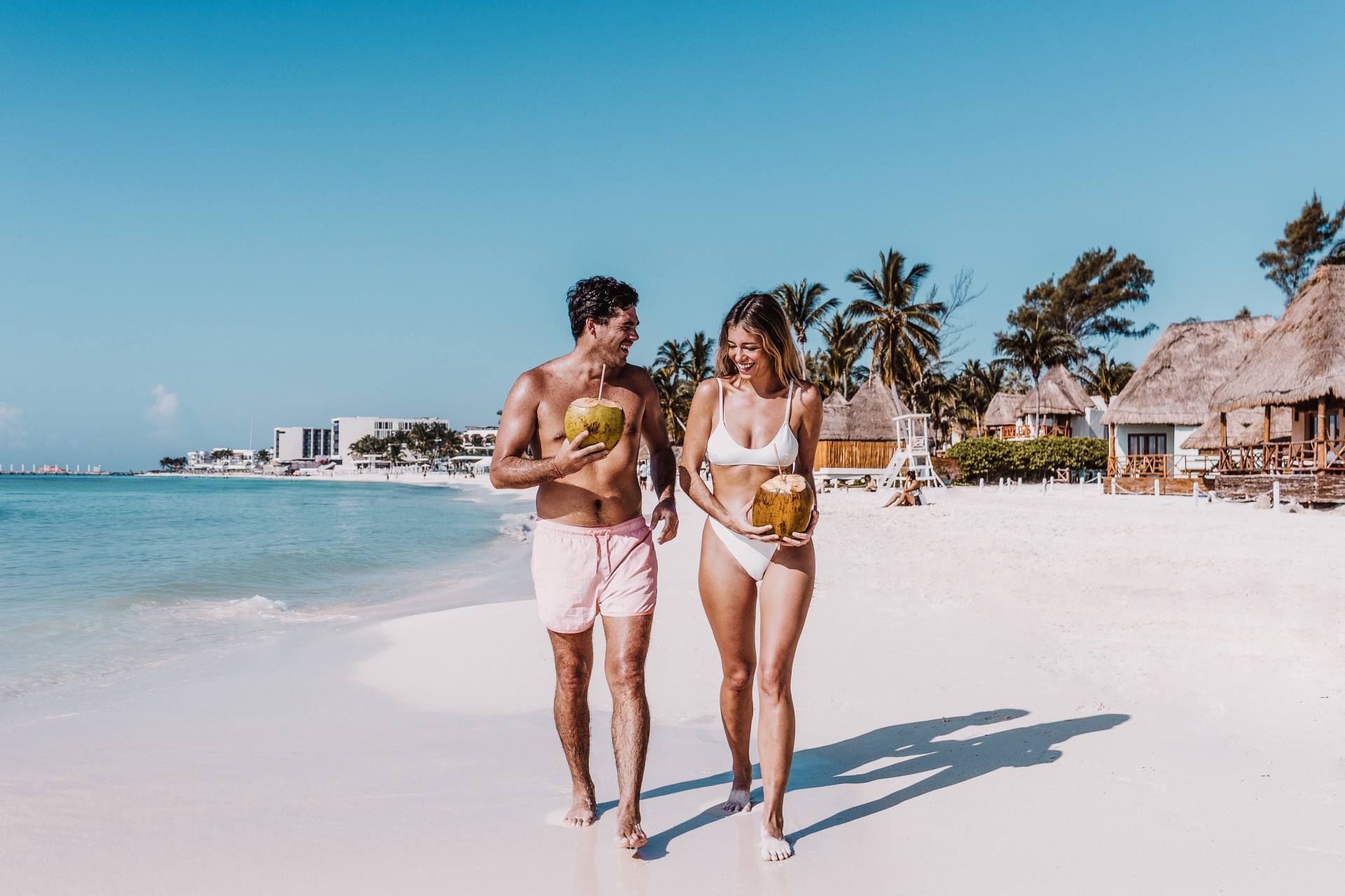 a man and woman walking on a beach