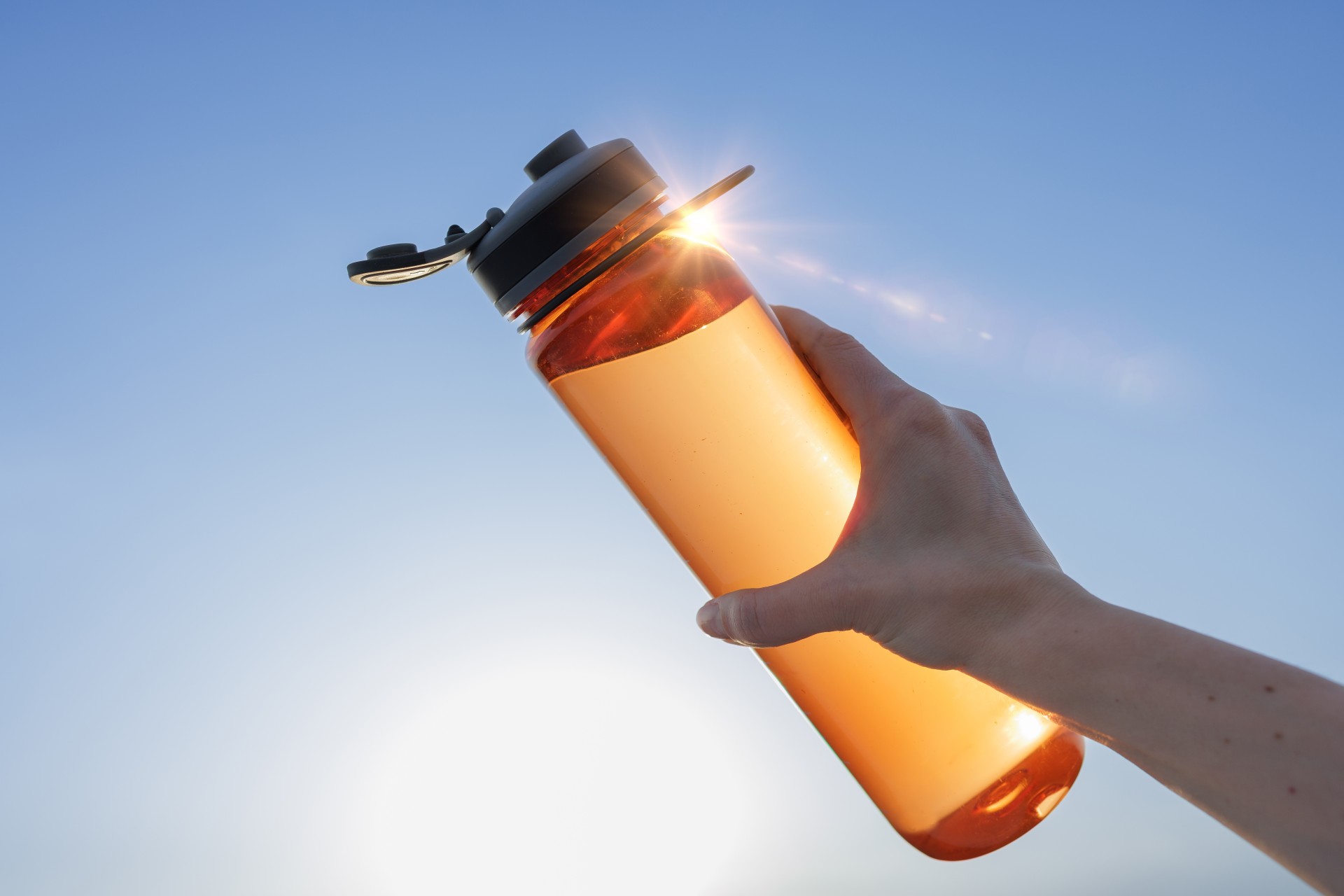 a hand holding a bottle of water