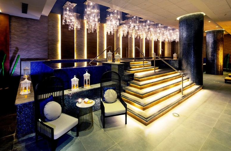 a room with stairs and chandeliers