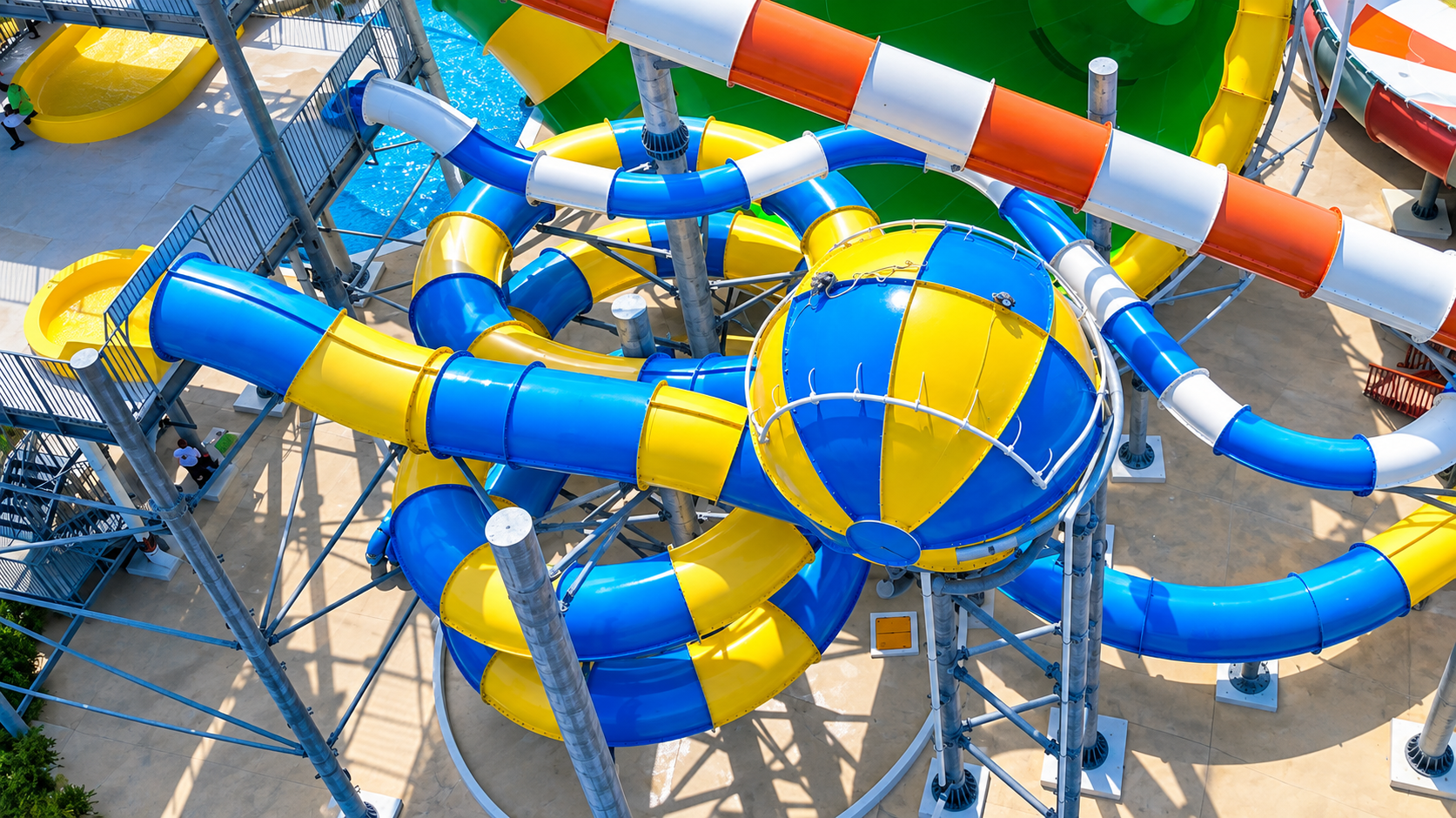 a water park with a large colorful tube and a ball