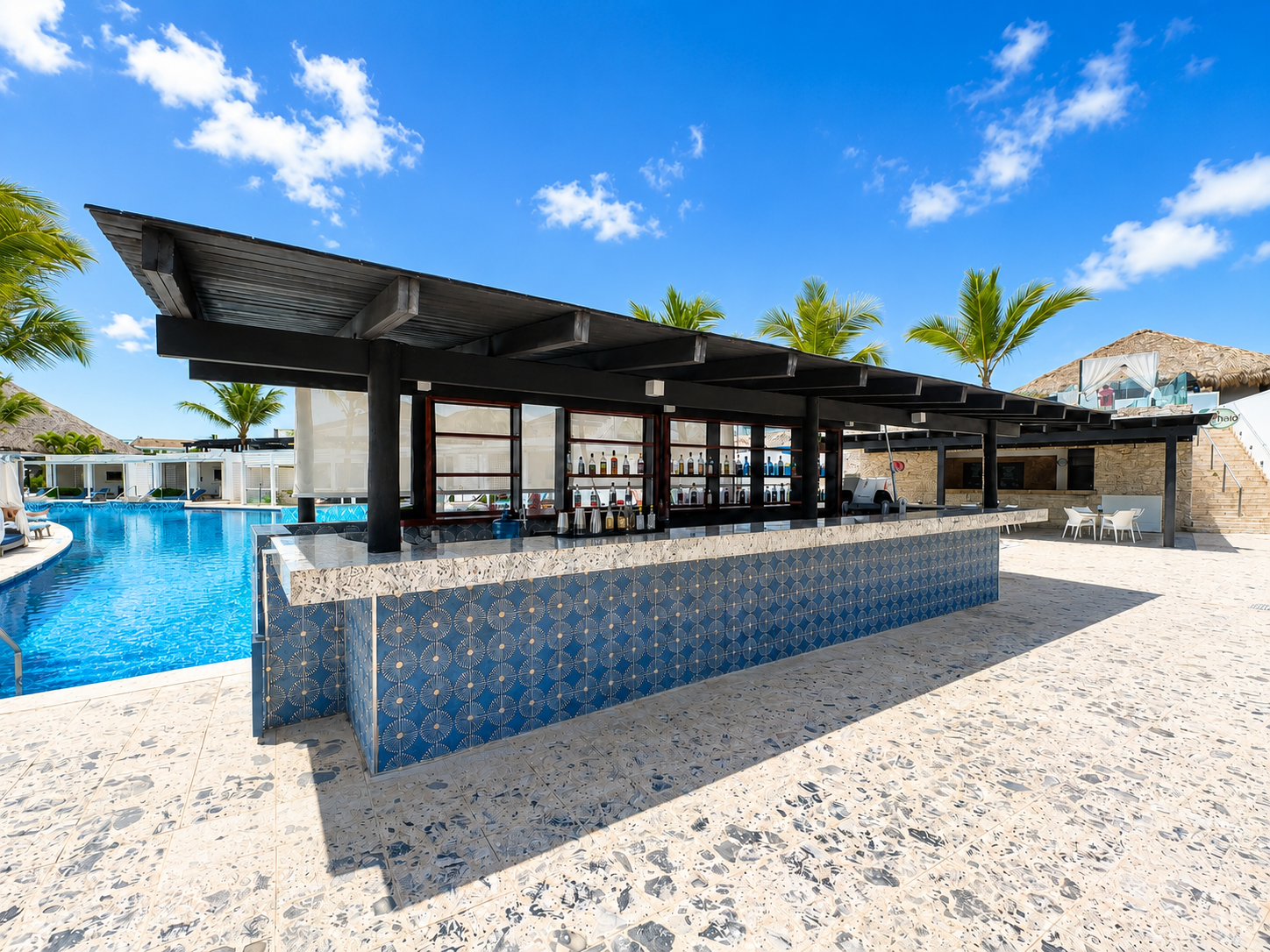 a bar with a pool in the background
