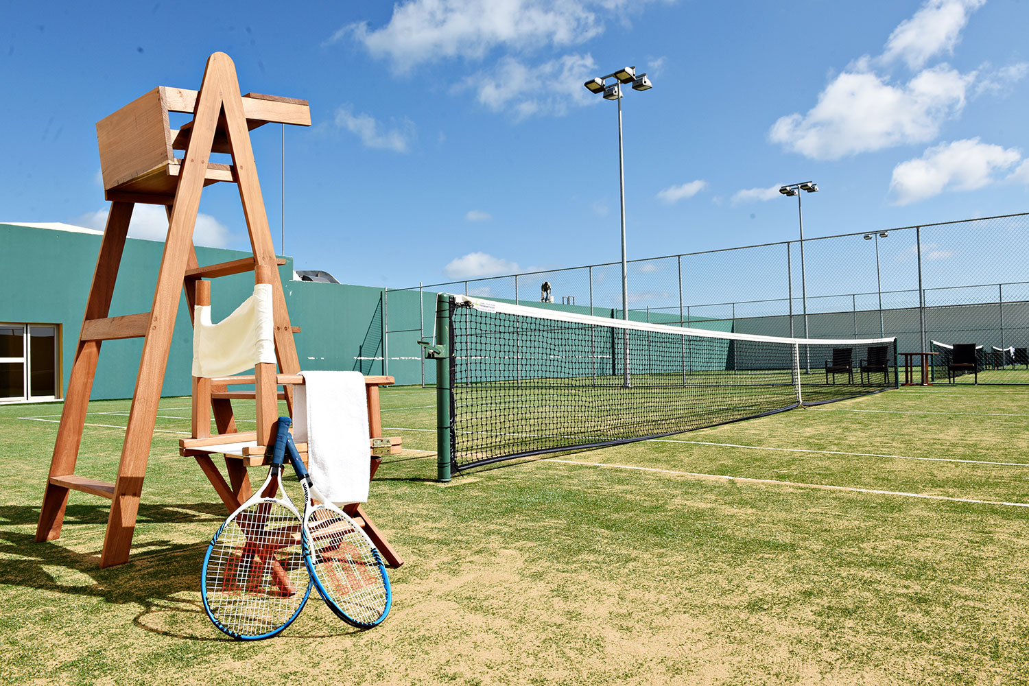 a chair and a tennis racket on a tennis court