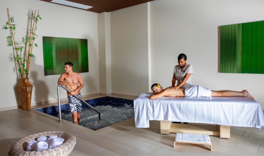 a woman getting a massage from a man in a hot tub