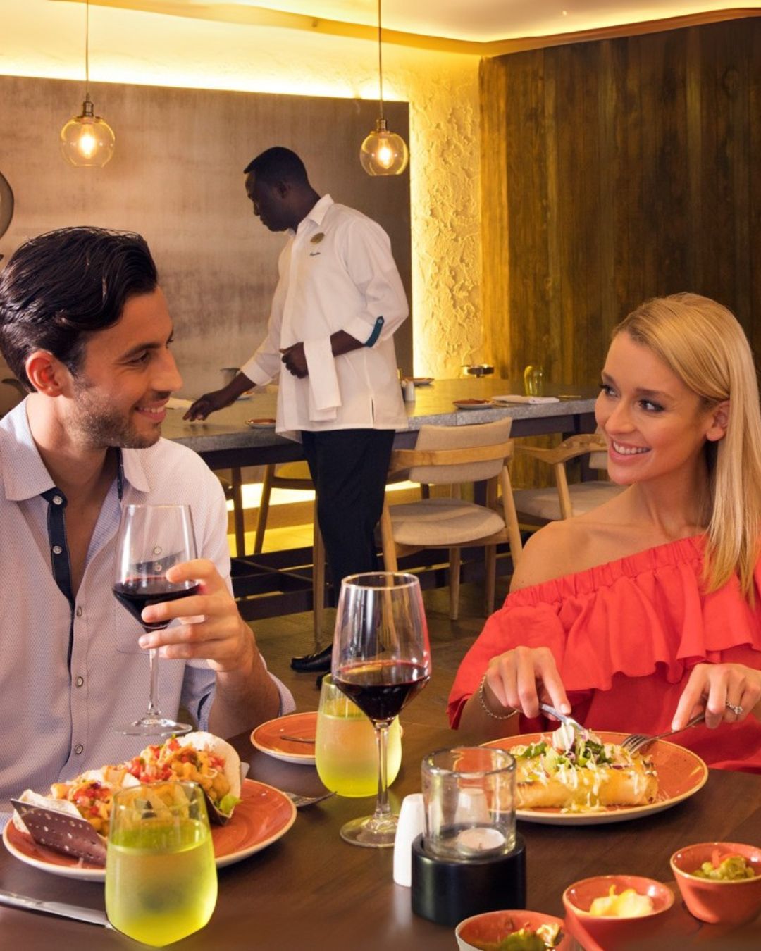 a man and woman eating at a restaurant