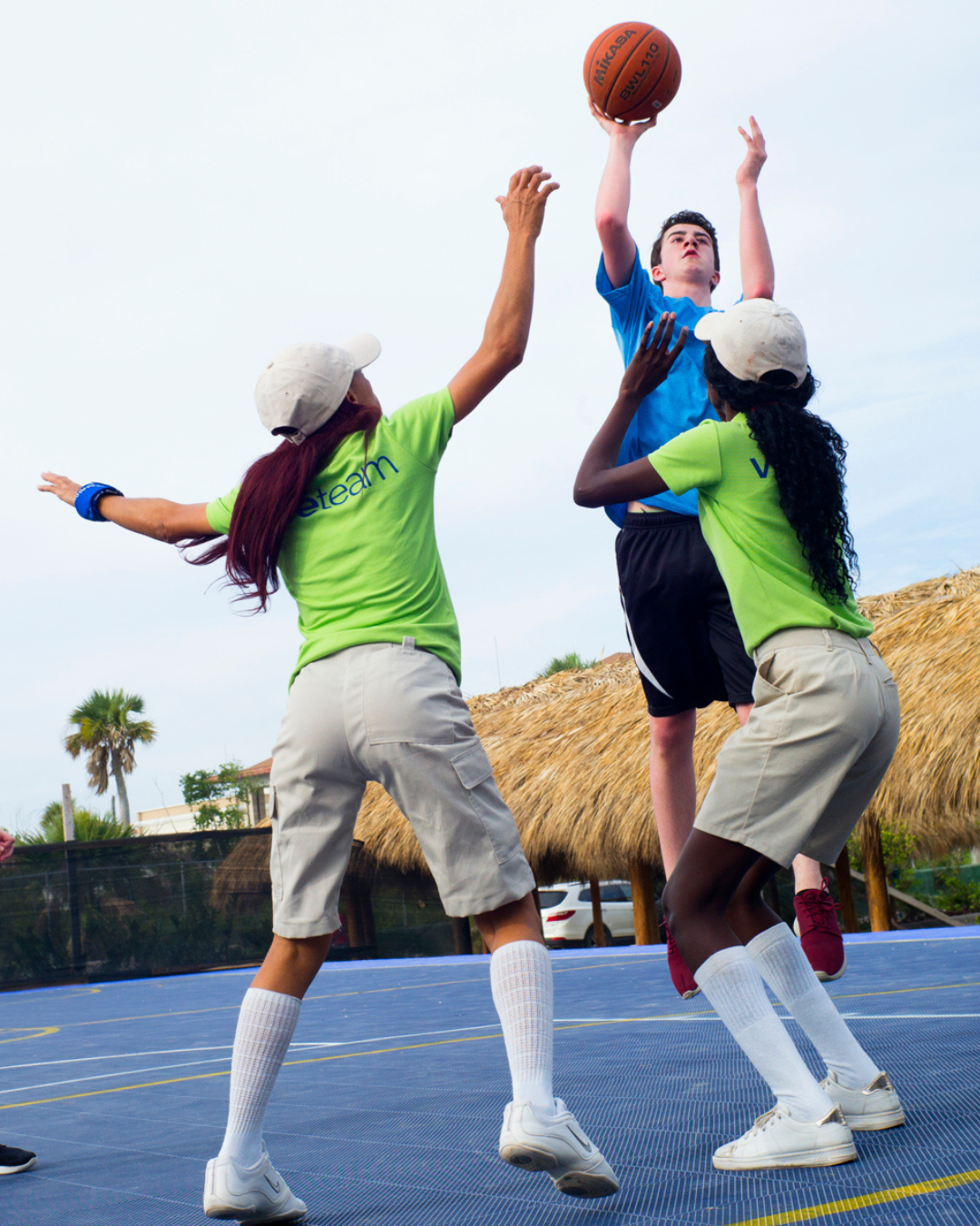 a group of people playing basketball