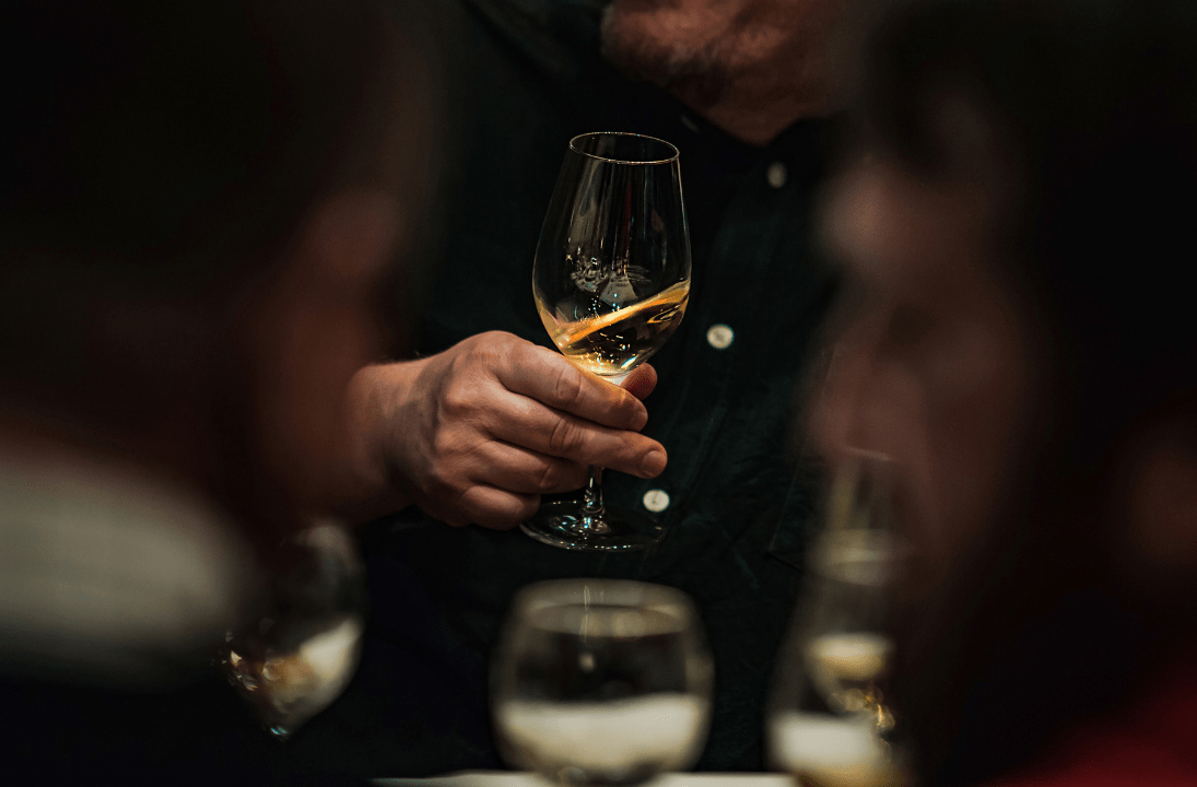 a person holding a wine glass