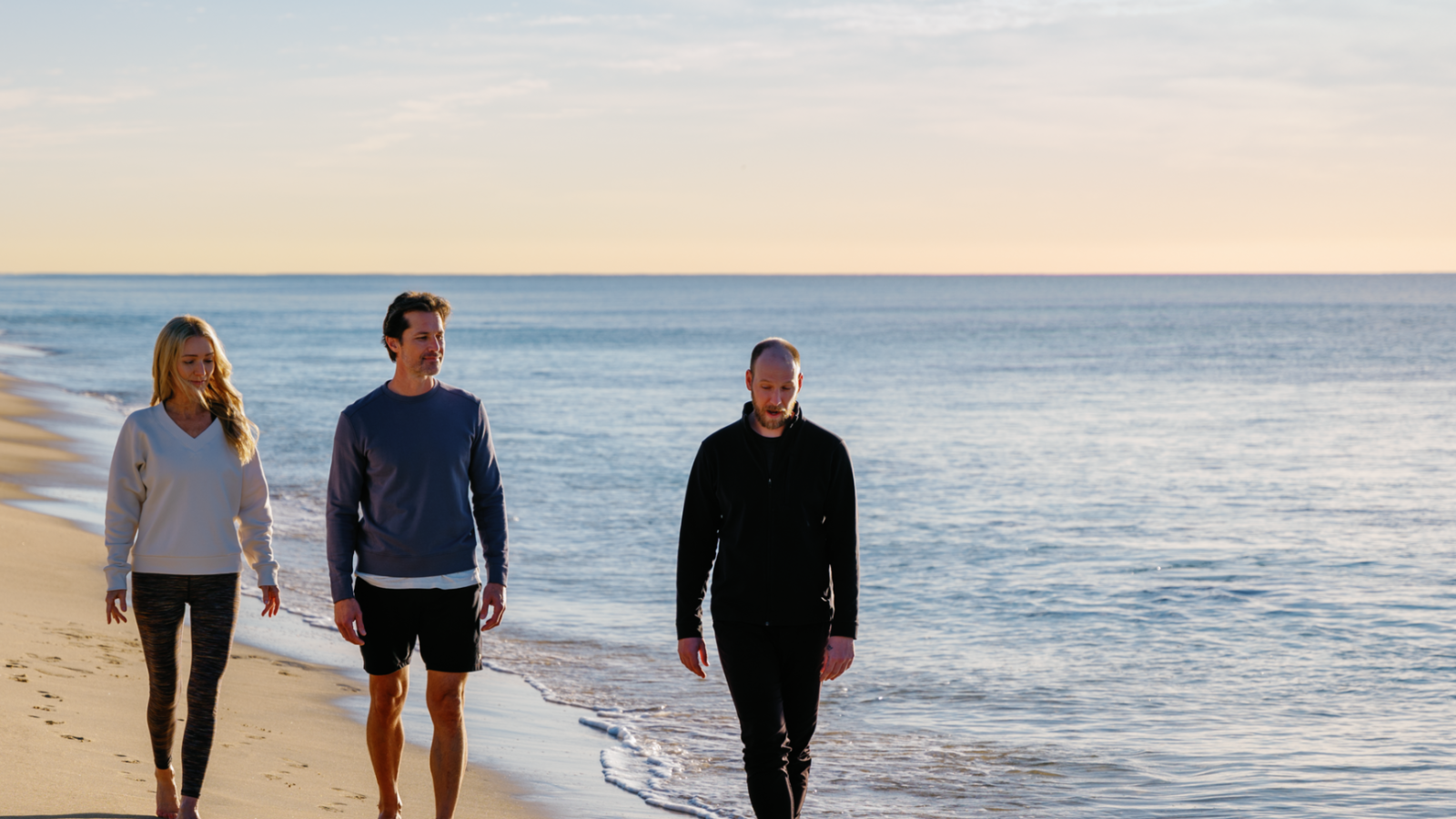 two men walking on a beach