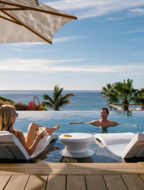a man and woman sitting in a pool