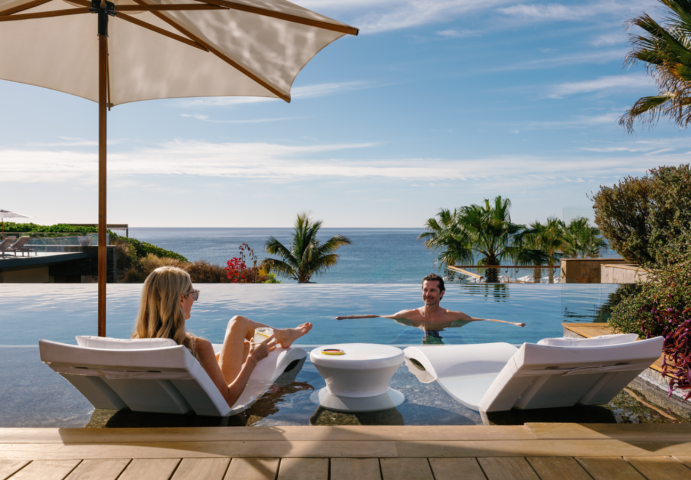 a man and woman sitting in a pool
