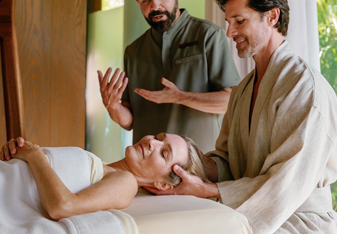 a man and woman lying on a bed