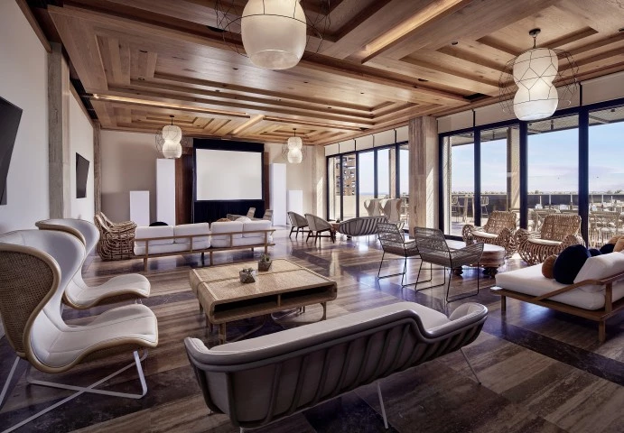 a room with a large screen and chairs