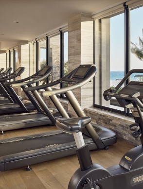 a group of treadmills in a room with windows