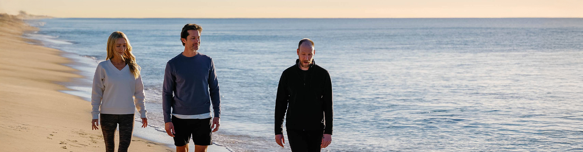 two men walking on a beach