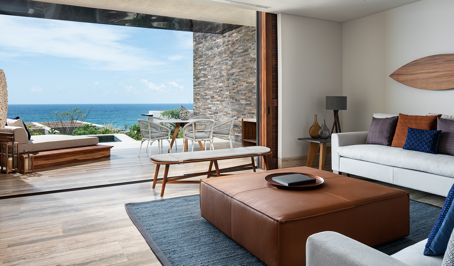 a living room with a view of the ocean