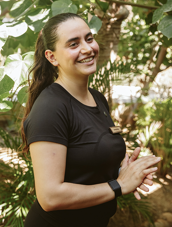 a woman smiling with her hands together