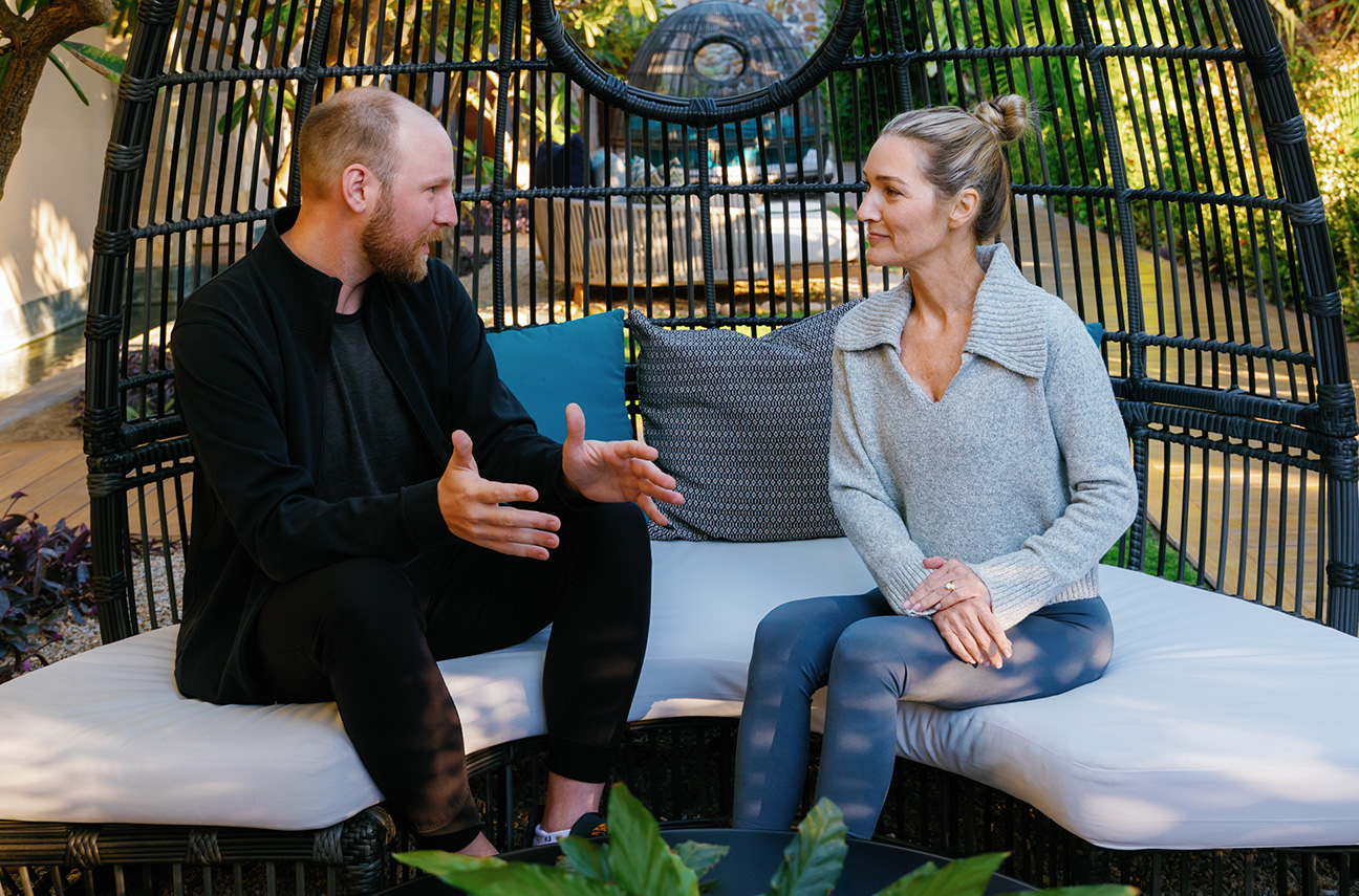 a man and woman sitting on a bench