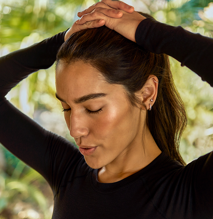 a woman with her hands on her head
