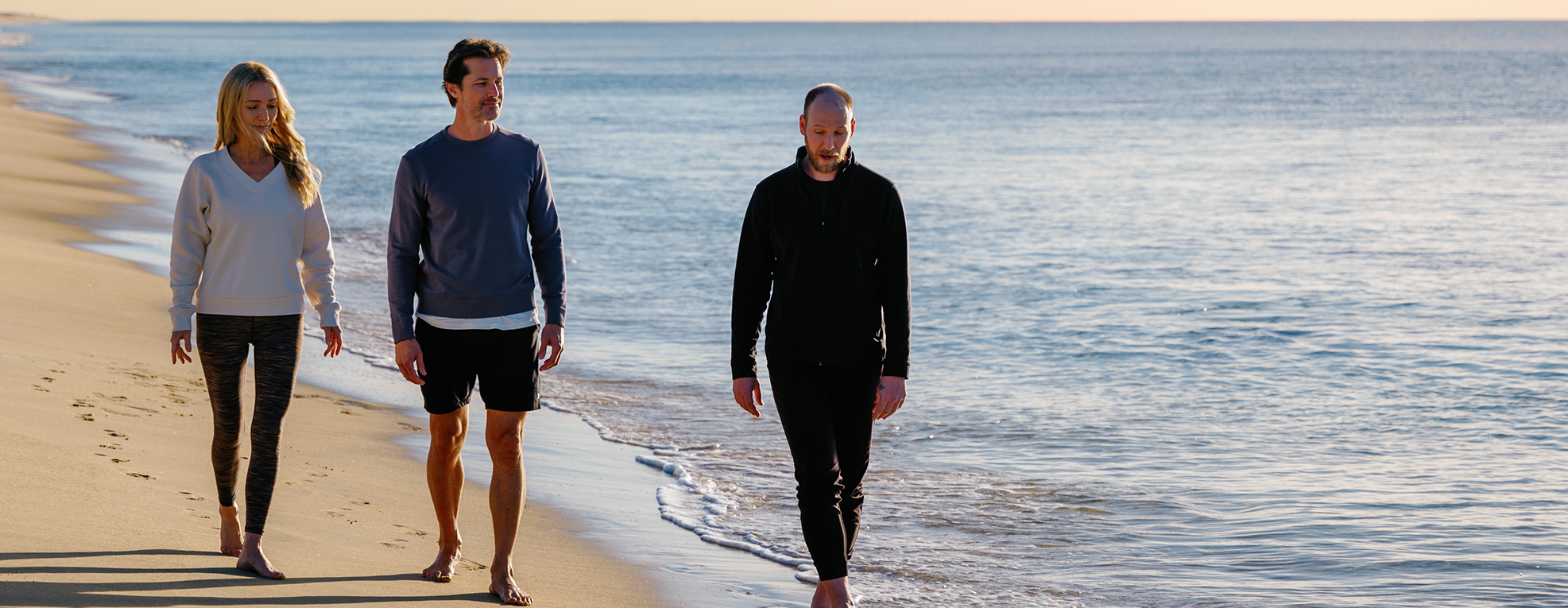 two men walking on a beach