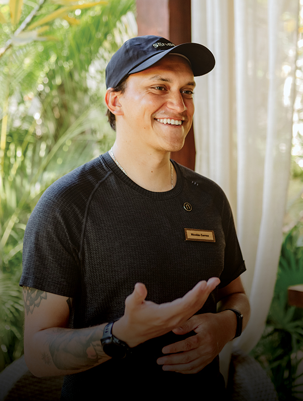 a man wearing a hat and smiling