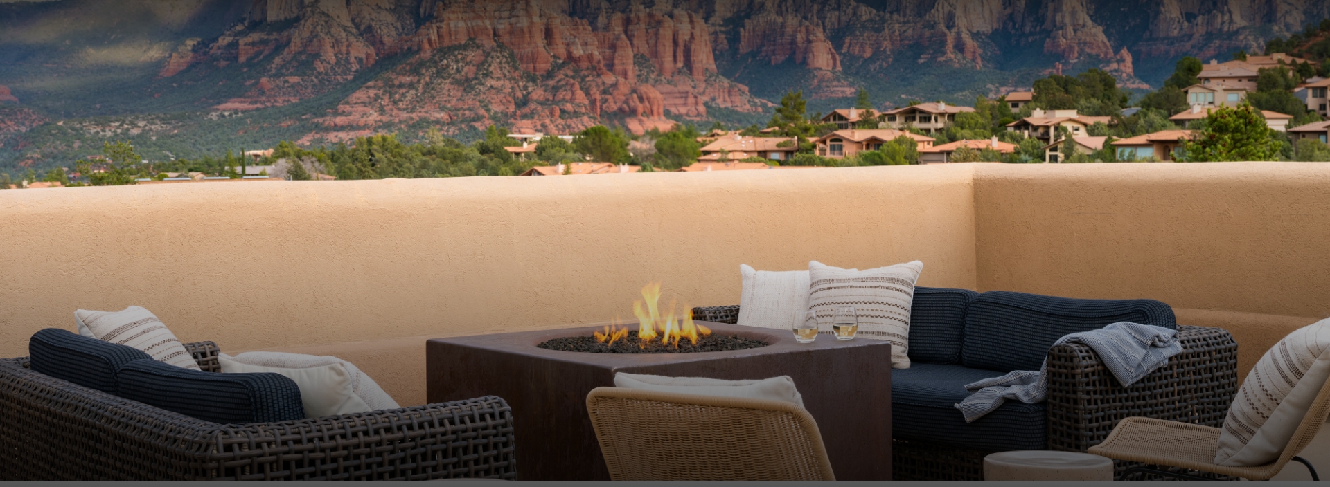 a fire pit with a view of mountains in the background