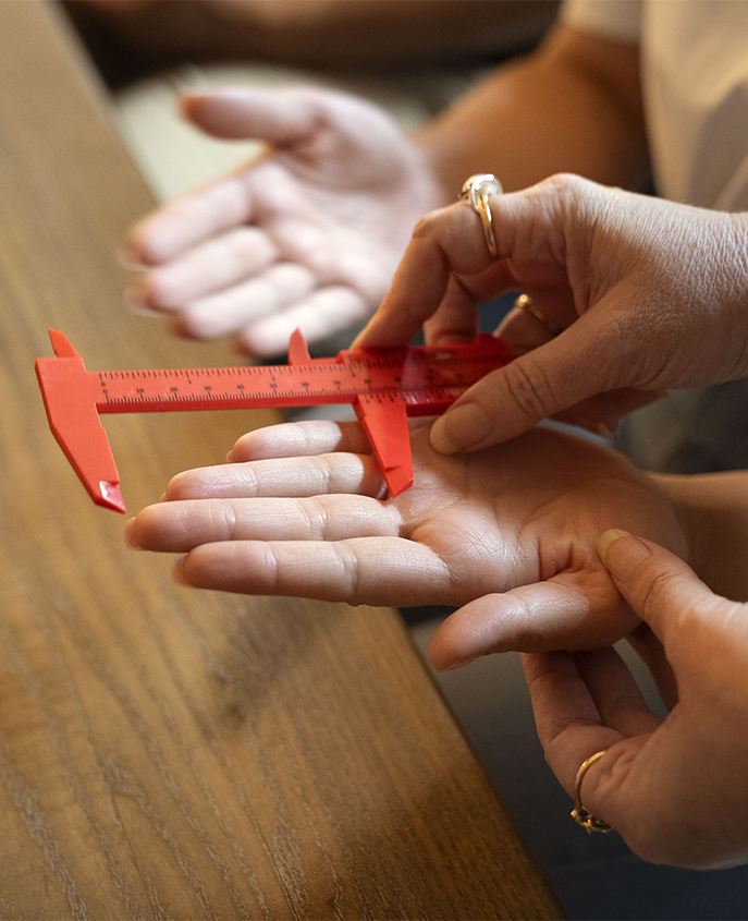 a person measuring a hand