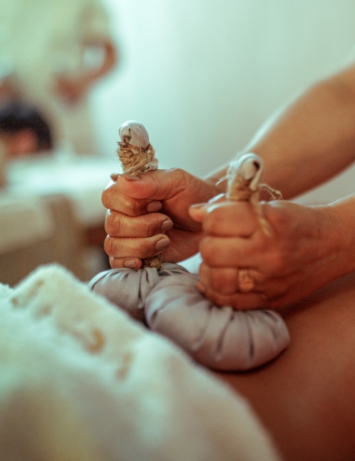 a close-up of hands holding a bag of herbal