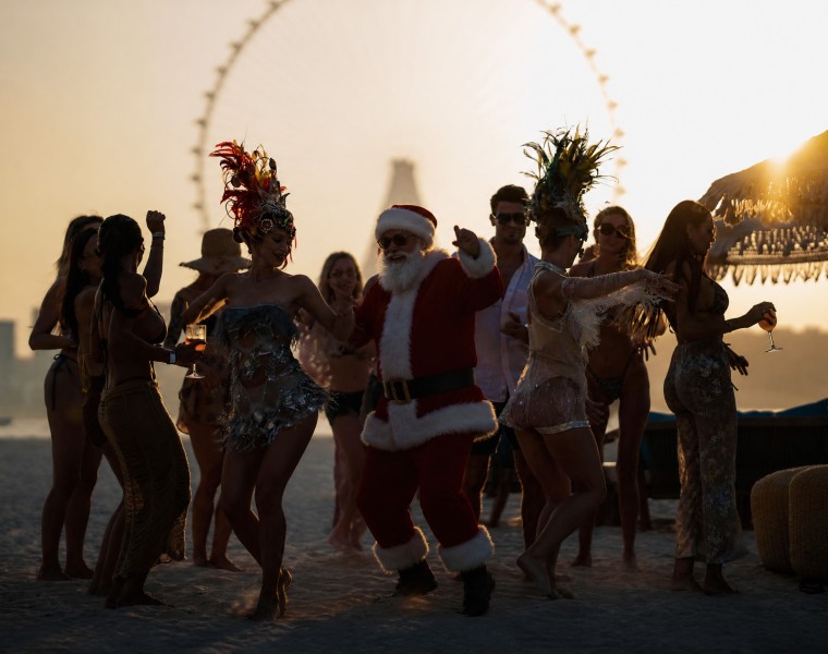 a group of people dancing on a beach