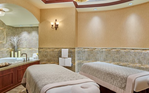 a massage room with two beds