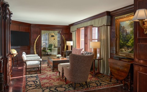 a room with a couch and chairs