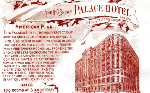 a red and white paper with a building and text