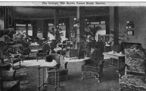 a black and white photo of a hotel lobby