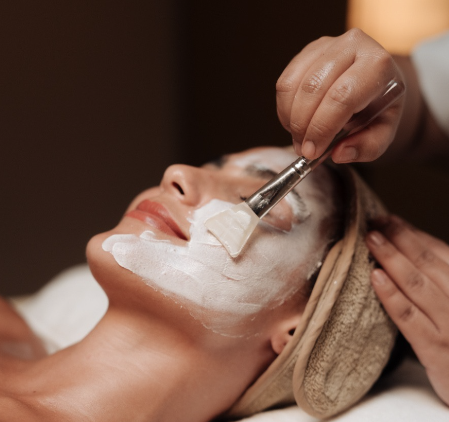 a woman receiving a facial mask