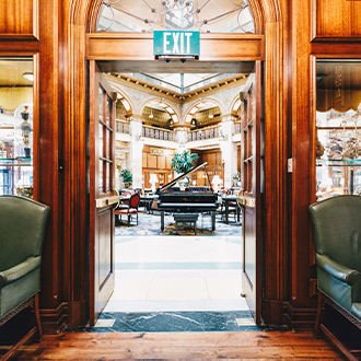 a room with a piano and chairs