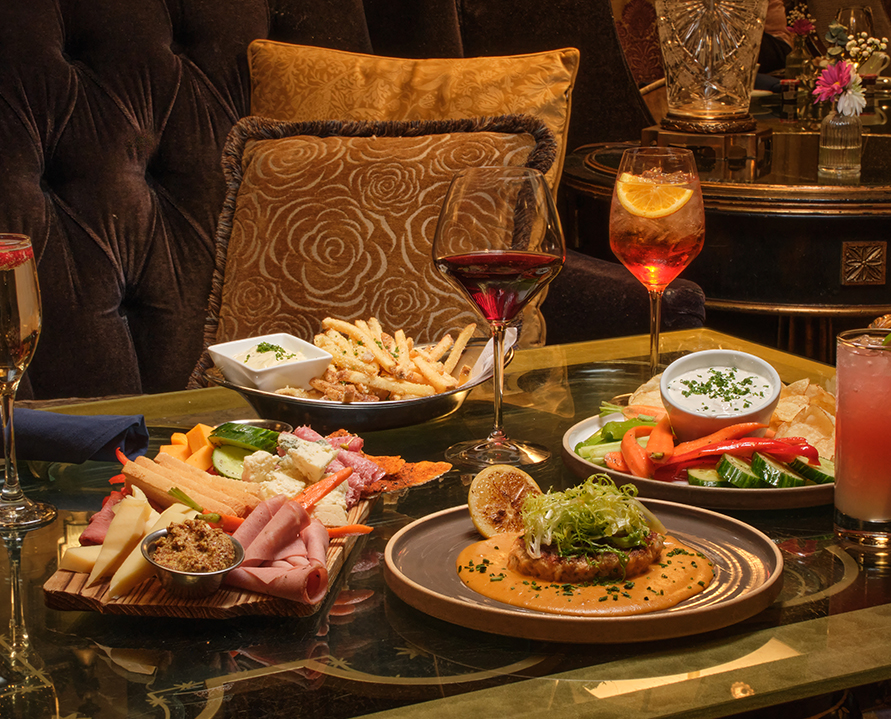 a table with plates of food and drinks