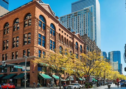 a city street with buildings and trees