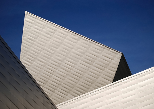 a white building with a triangular roof