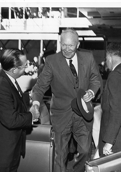 a man in a suit shaking hands with another man in a suit