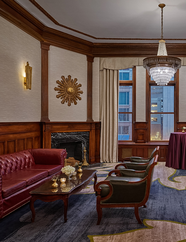 a room with a couch and chairs