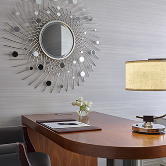 a desk with a mirror on the wall