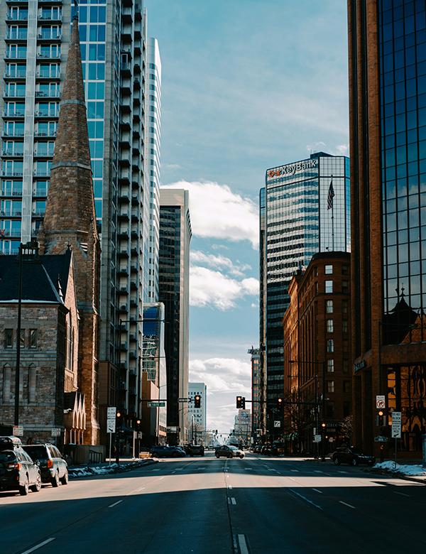 a street with cars and buildings in the background