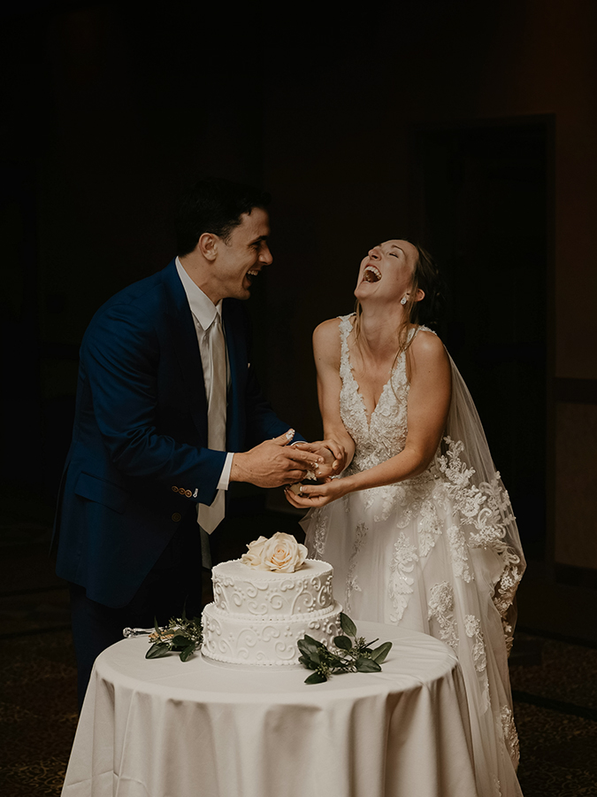 a man and woman cutting a cake
