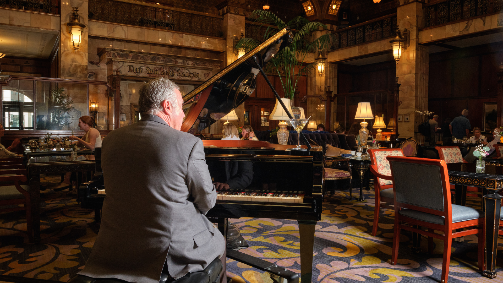 a man playing a piano in a room