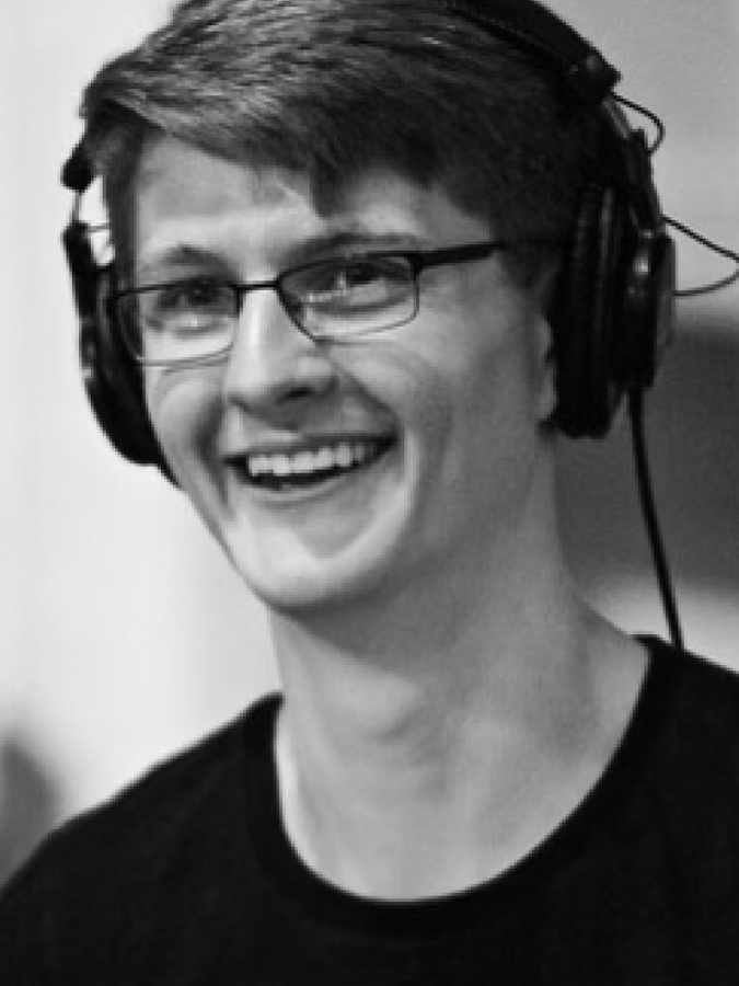 a man wearing headphones and smiling