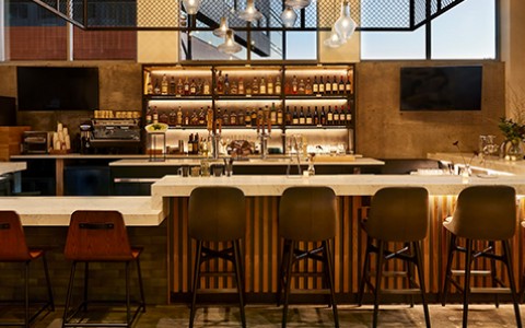 shot of the bar with two tv sets mounted on the wall