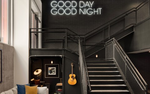 a staircase with a guitar on the wall