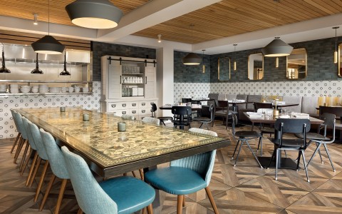 a large table with chairs and a large mirror in a restaurant